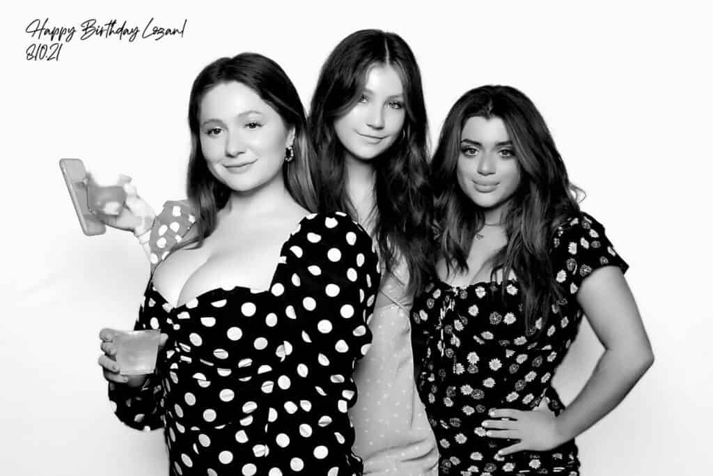 emma kenney posing with friends at beauty booth at birthday party for logan