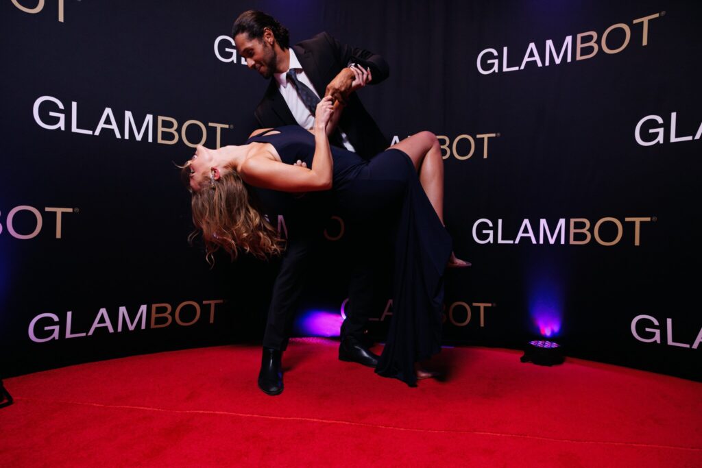 Guests posing for a cinematic GlamBot slow-motion video on a red carpet